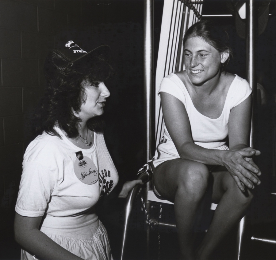 two women talk in a black and white photo